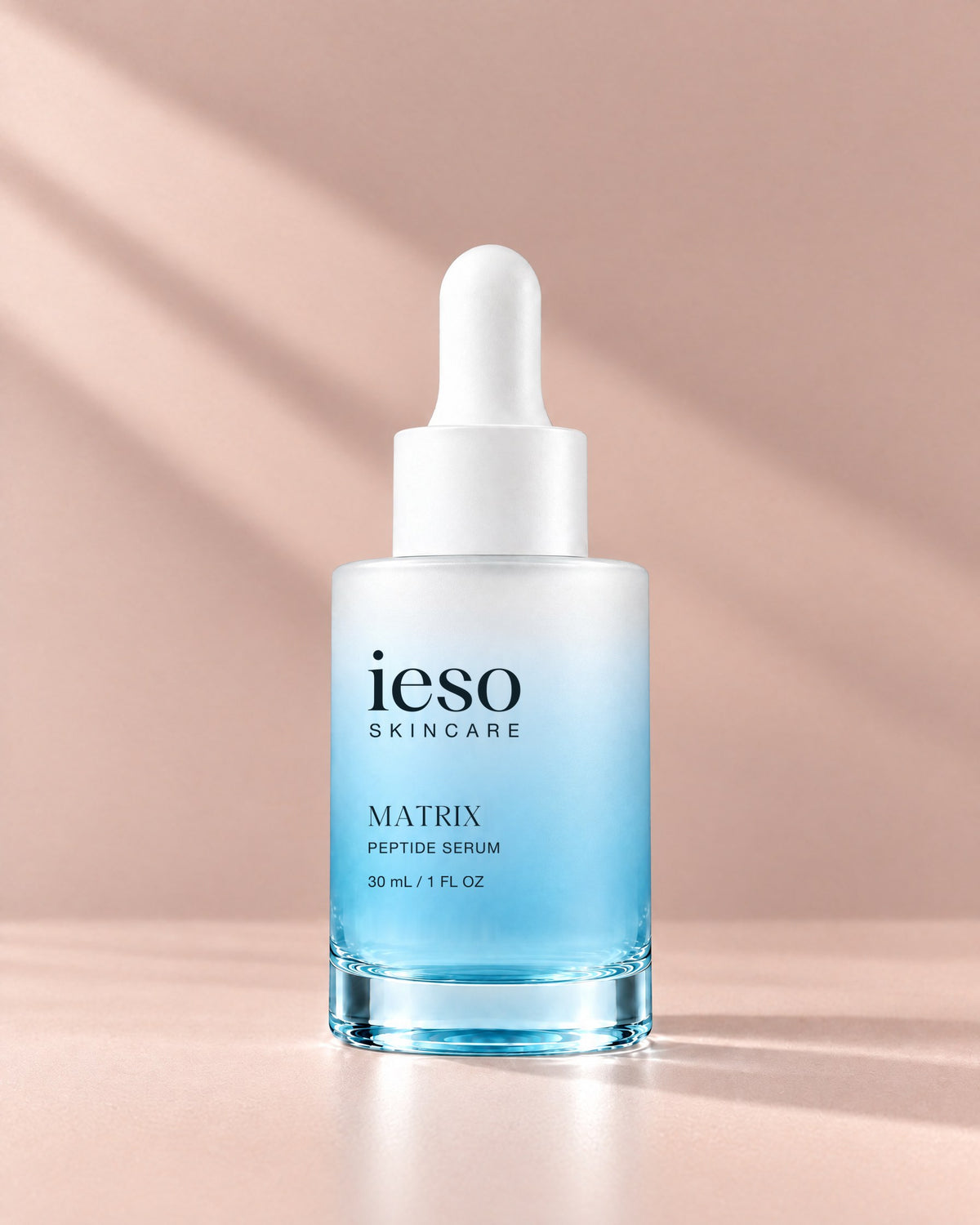 MATRIX Peptide Serum by Ieso Skincare, 30 mL frosted dropper bottle on a blush background with soft window light